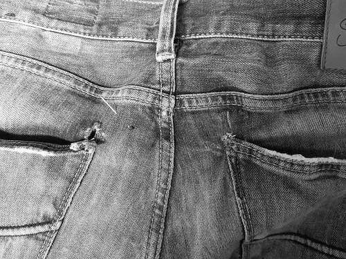 Gebrauchte Jeans vor dem Flickservice im Änderungsatelier Rusta